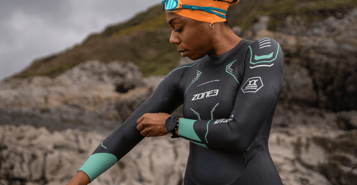 Person wearing a wetsuit with a mountainous background